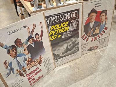 three movie posters on display in a store
