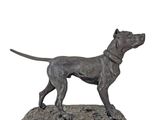 bronze statue of a dog standing on a wooden base