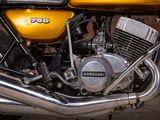 a close up of a yellow motorcycle parked in a parking lot