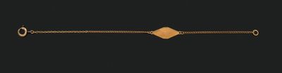 a gold bracelet with a diamond on it on a black background