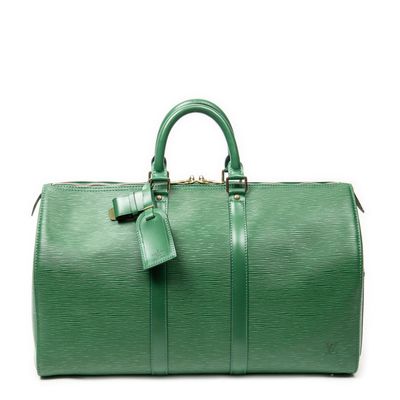 a green duffel bag sitting on top of a white surface