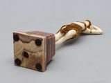 a small wooden object with a snake on top of it