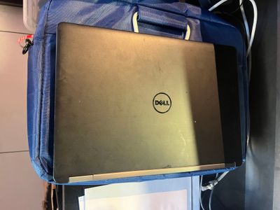 a laptop that is sitting on top of a blue bag