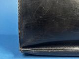 a black leather purse with a zipper closure on the front