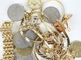 a pile of gold and silver coins on a white surface
