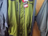 two jackets and a pair of skis hanging on a rack