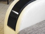 a white couch with a black stripe on the arm