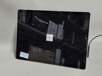 un ordinateur portable sur lequel est collé un autocollant, posé sur une table