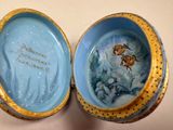 a blue and yellow box with a painting on it