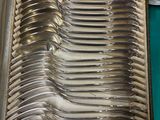 a lot of silverware in a case on a table