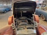 an old car that is parked in a garage