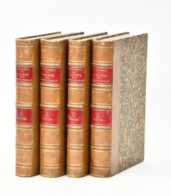 three old books sitting on top of each other on a white surface