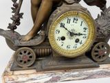 a statue of a woman sitting on a clock