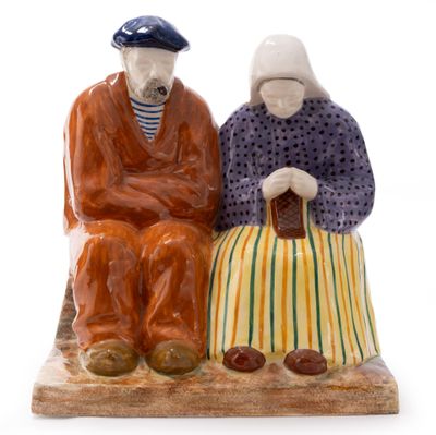 a figurine of two people sitting on a bench