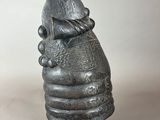 an image of a sculpture of a hand holding a fish