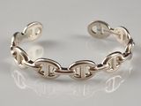 sterling silver bracelet with links and clasps on a white surface