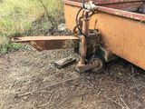 a rusted out trailer sitting in the grass