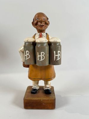 a figurine of a woman holding three barrels