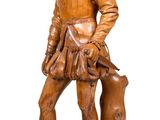 wooden statue of a boy with a dog on a white background