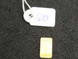 a small piece of gold next to a smaller piece of gold