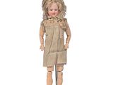 an image of a wooden doll standing on a white surface