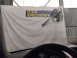 a car with a banner hanging on the side of it