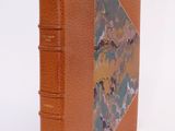 orange leather book with a marbled cover on a white background