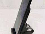 a cell phone that is on a stand on a table