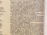 an old book with writing on it sitting on a table