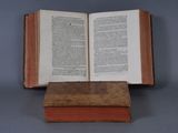 an open book sitting on top of an old book