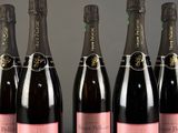 a group of six bottles of champagne sitting on top of a table
