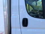 a white truck with a red sticker on the side of it