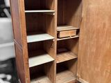 a wooden cabinet with shelves and shelves inside of it