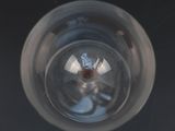 a close up view of a glass of water with a red object in it