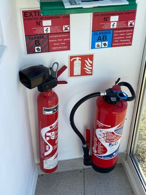 a fire extinguisor next to a fire extinguisor