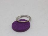 a ring that is sitting on top of a purple piece of felt