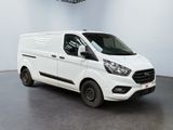 the white van is parked in a large room with a ceiling fan
