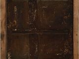an old wooden door with a brown stain on it