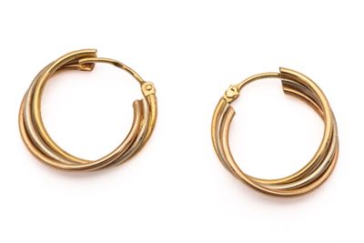 a pair of gold hoop earrings on a white background