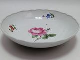 a white bowl with a flower design on it