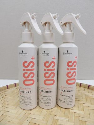three bottles of soap sitting on top of a bamboo tray