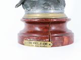 a statue of a man riding a horse on a pedestal
