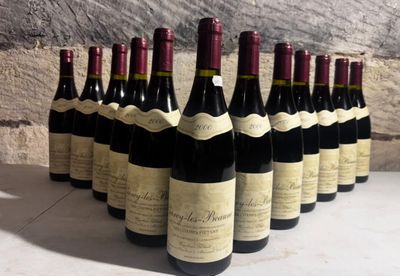 several bottles of wine are lined up in a row on a table