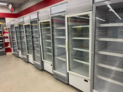 a row of empty refrigerators in a store