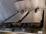 a picture of a commercial fryer with two pans on it