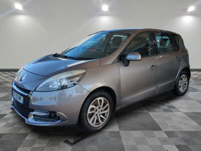 the small silver car is parked in a room with a checkered floor