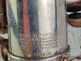a close up of a silver saxophone with a red stripe on it