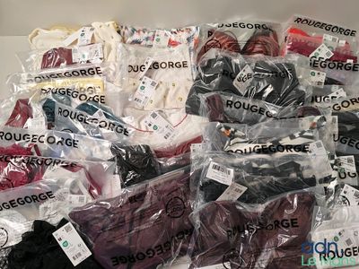 many different types of clothing in bags on the table
