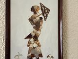 painting of a woman holding an umbrella on a wall