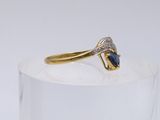 an image of a gold ring with a sapphire stone on top of it